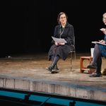 Theatre critic Lyn Gardner and Nadya Bettioui (Secondary and FE Programme Manager) sit on chairs on a stage
