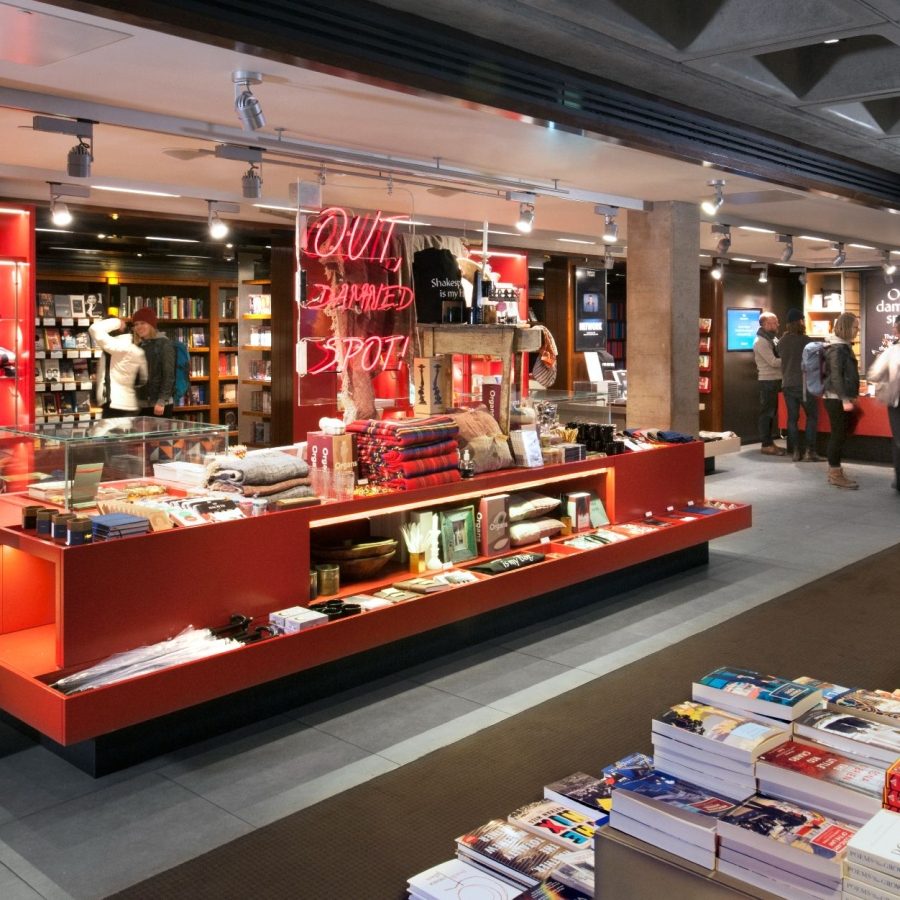 The Bookshop in the ground flooor foyer of the National Theatre, with tables and display cabinets of books and merchandise.