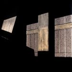Images of four fragments of concrete exterior wall panels on a black background