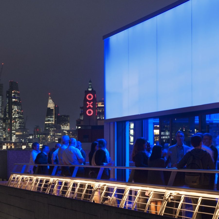 Buffini Chao Deck event hire space exterior night looking east to the City, with OXO Tower lights in red