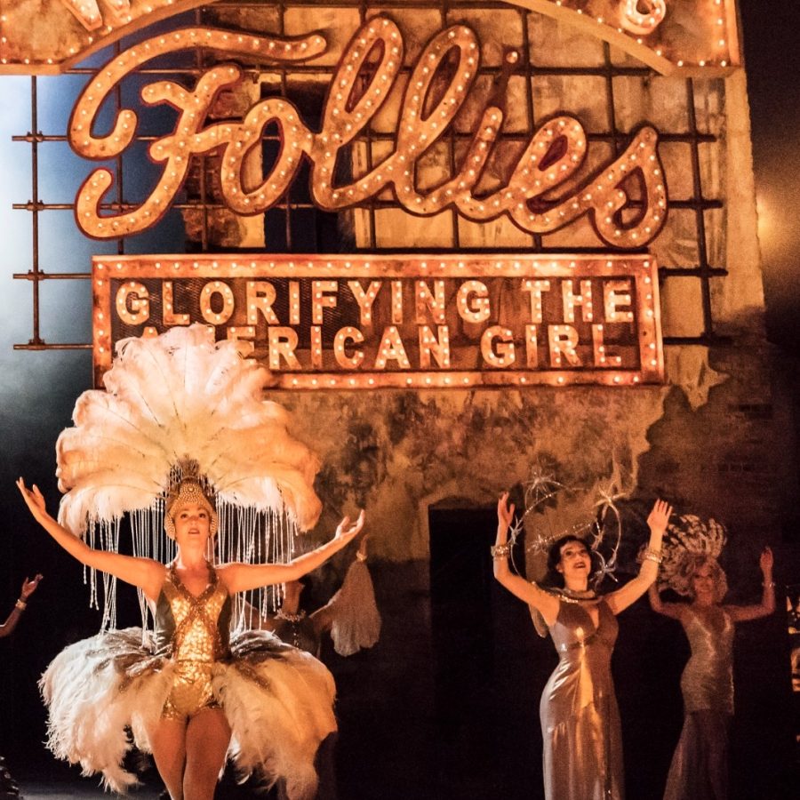 The original cast of Follies, with dancers wearing bird feather-plumed head-dresses and skirts.